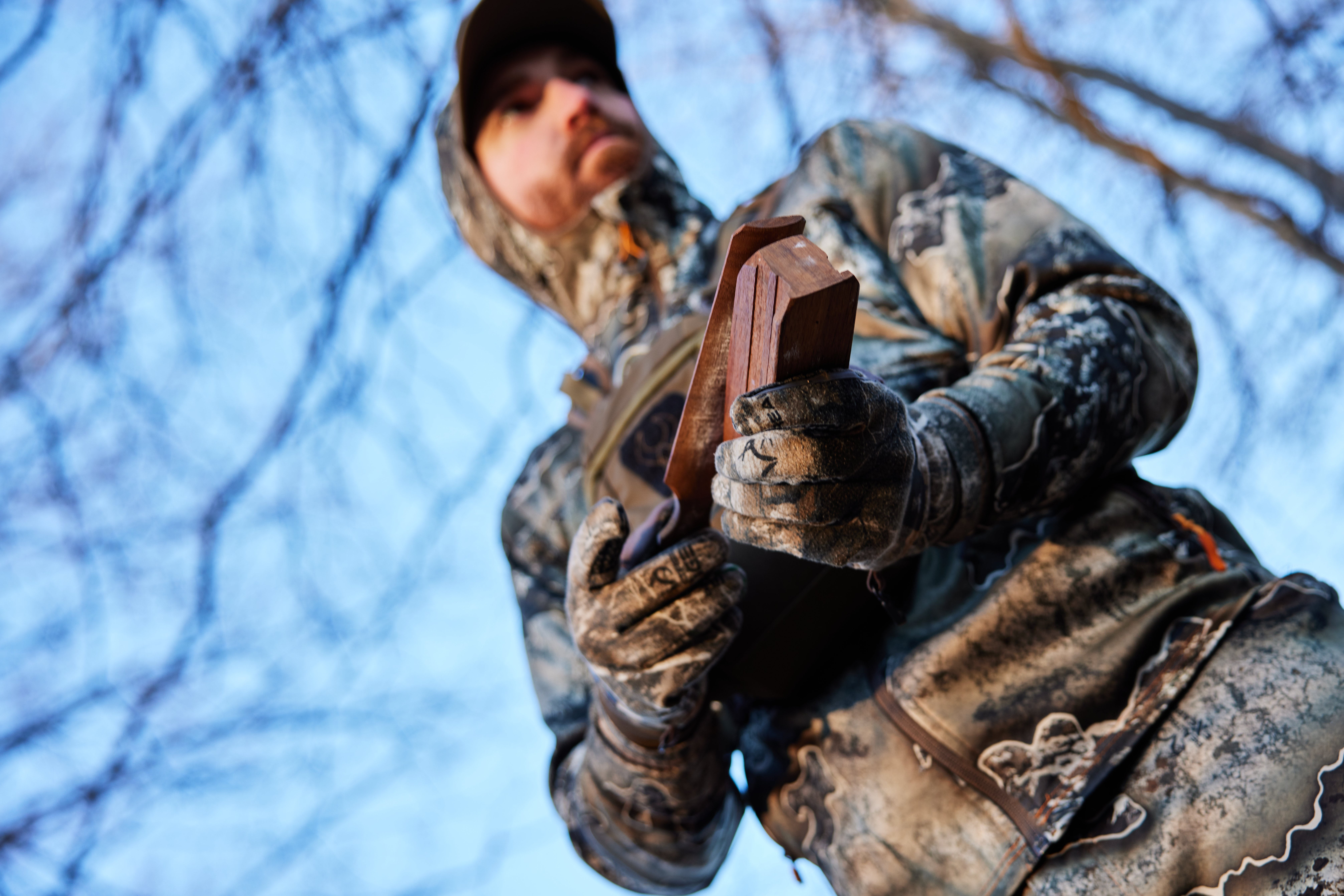 A hunter uses a turkey call on a hunt. 