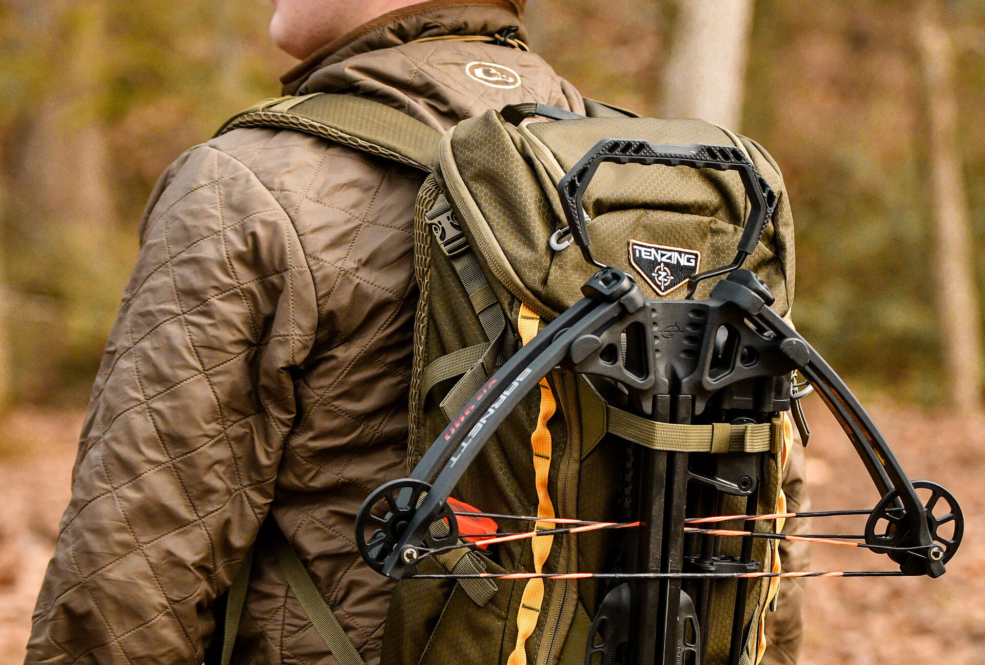 A hunter with a crossbow strapped to his gear pack. 