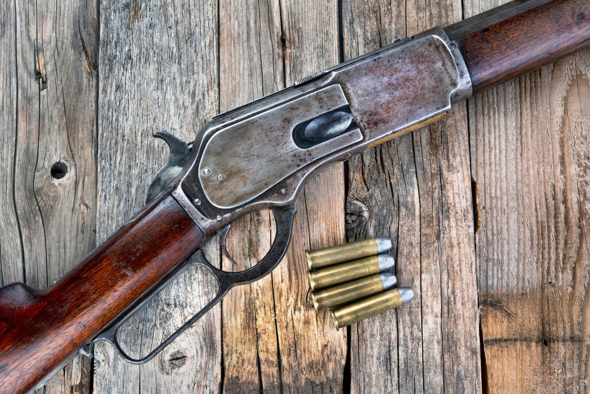 A rifle laying next to ammunition on a table, gun calibers concept. 