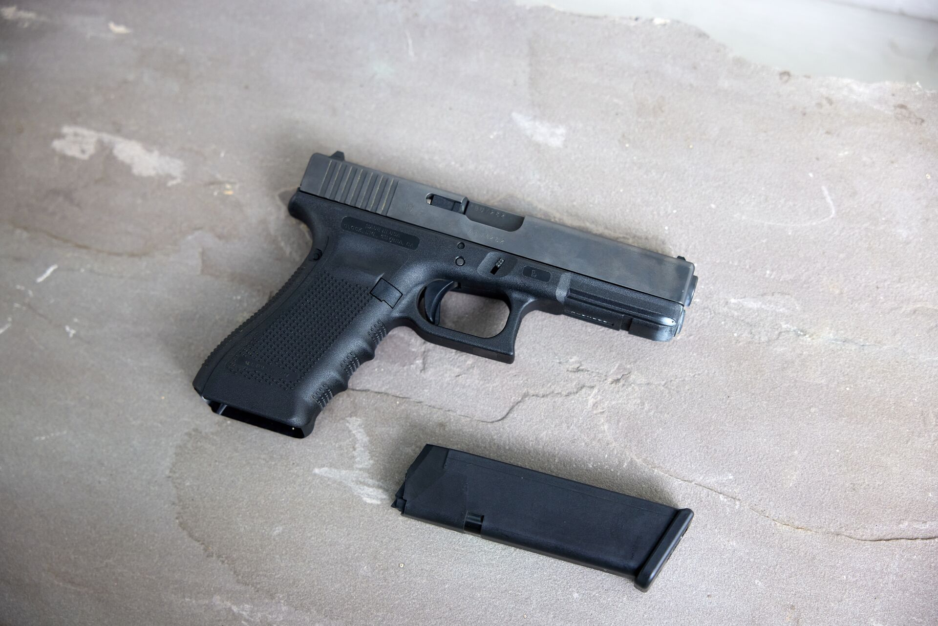 A Glock and a clip on a table. 