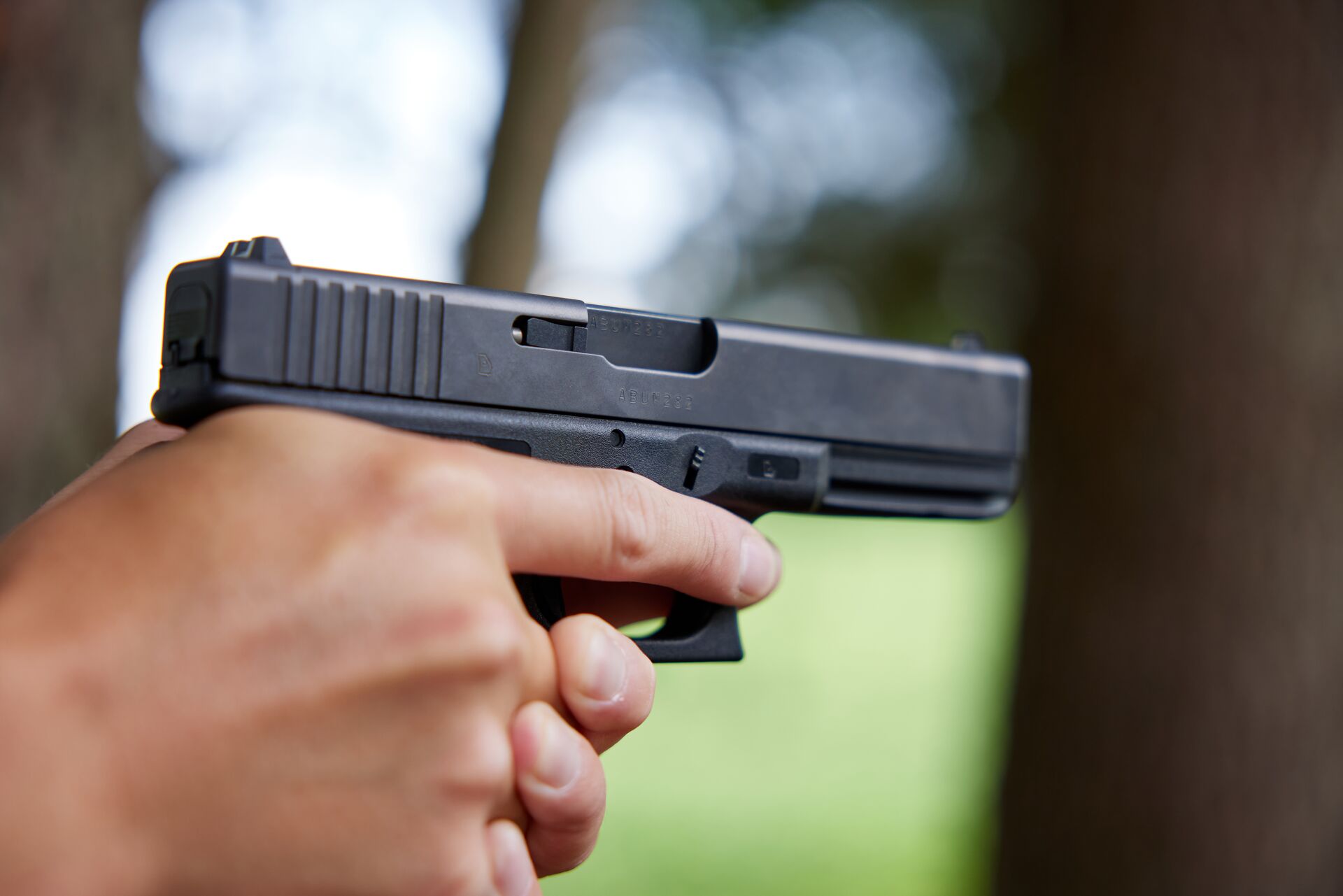 Close-up of hands holding a handgun. 