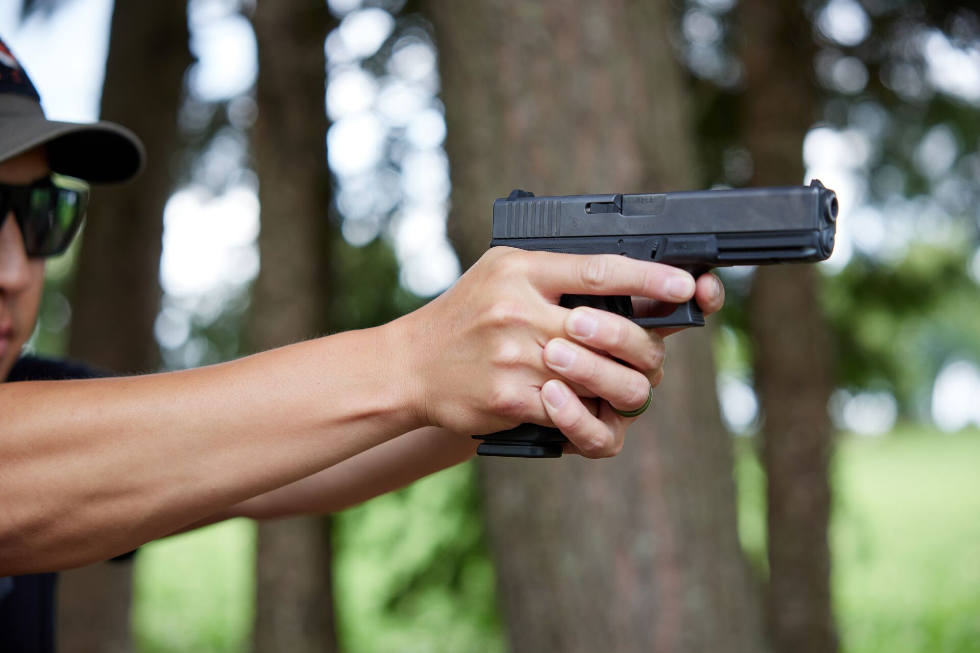 A hunter aims a handgun, hunting hogs with the right firearm concept. 