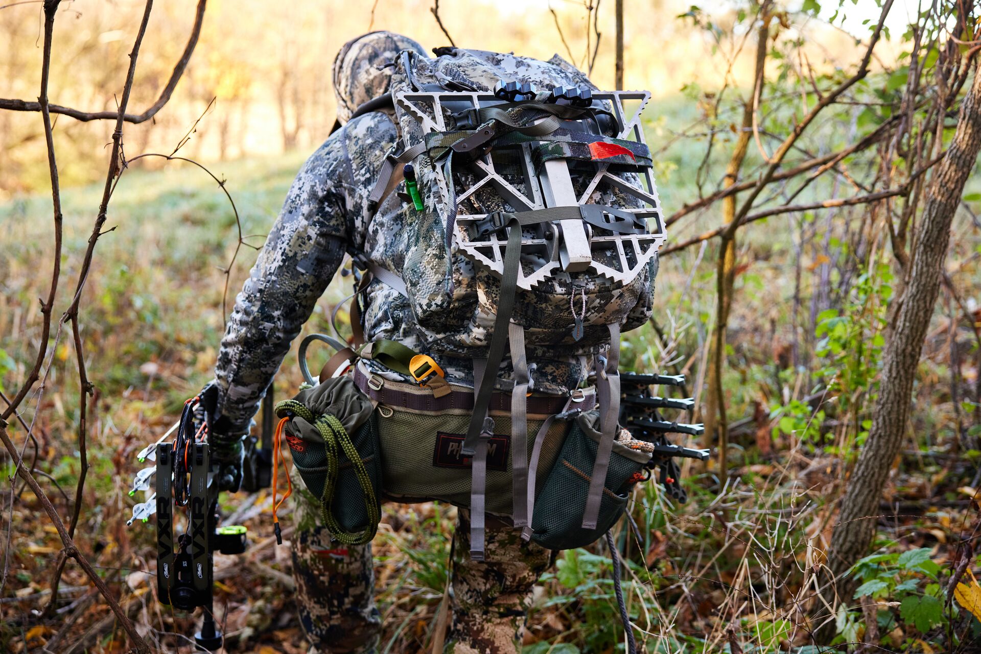 A hunter carries gear into the woods for a hunt. 