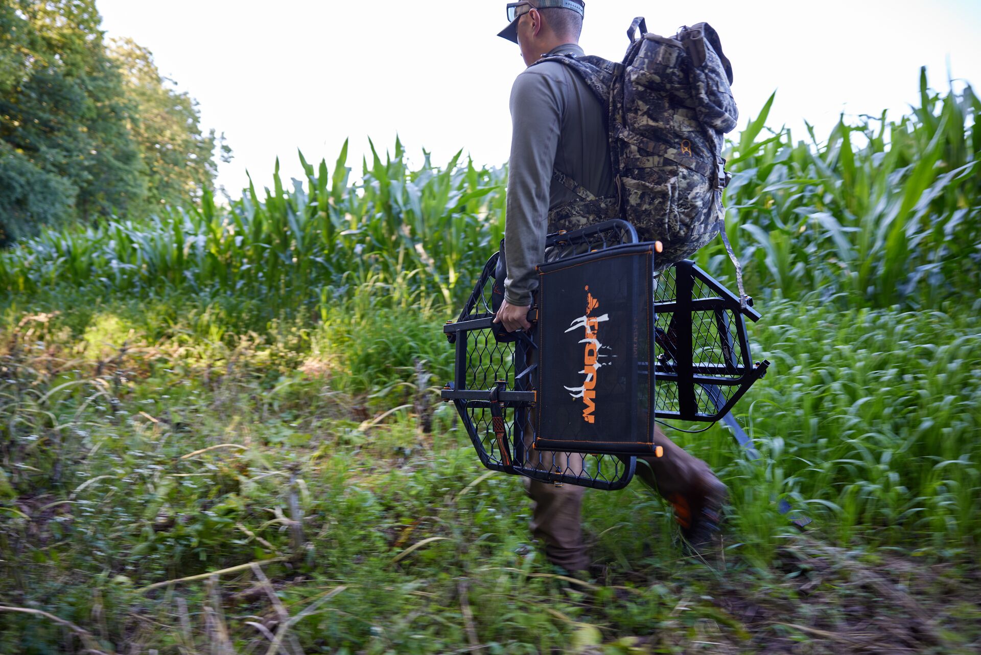 A hunter carries gear into the field for a hunt. 
