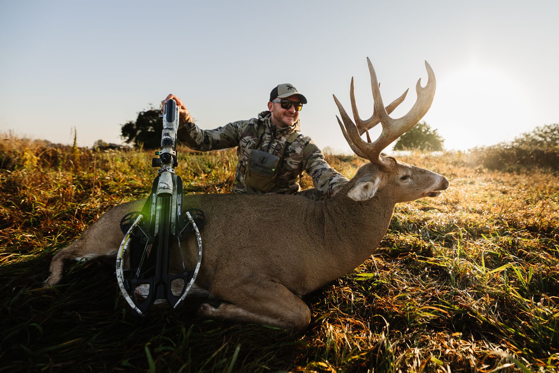 Hunter with a buch on the ground after a hunt, deer season opening day concept. 