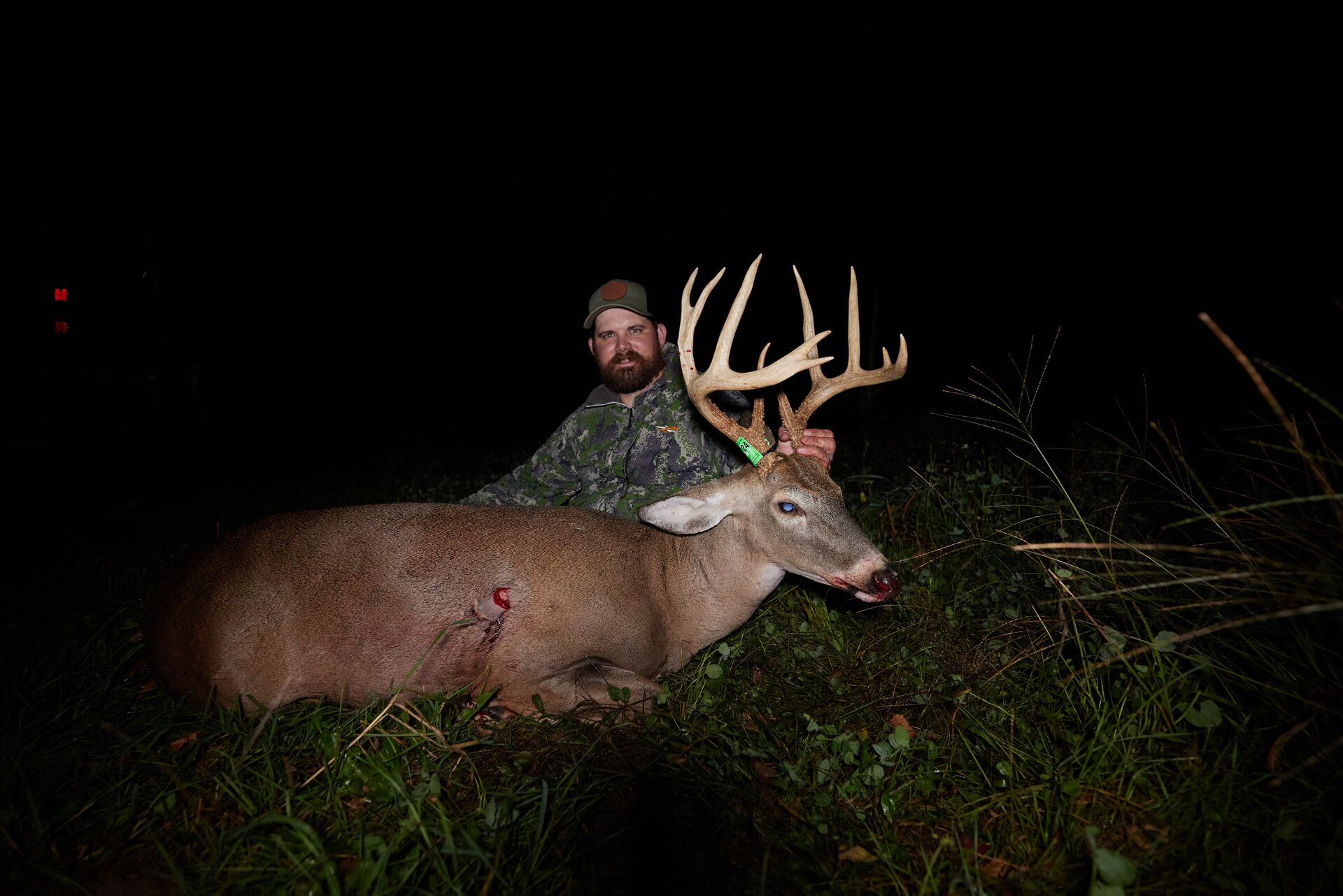 Hunter with big buck after hunt at night, early season deer hunting concept. 