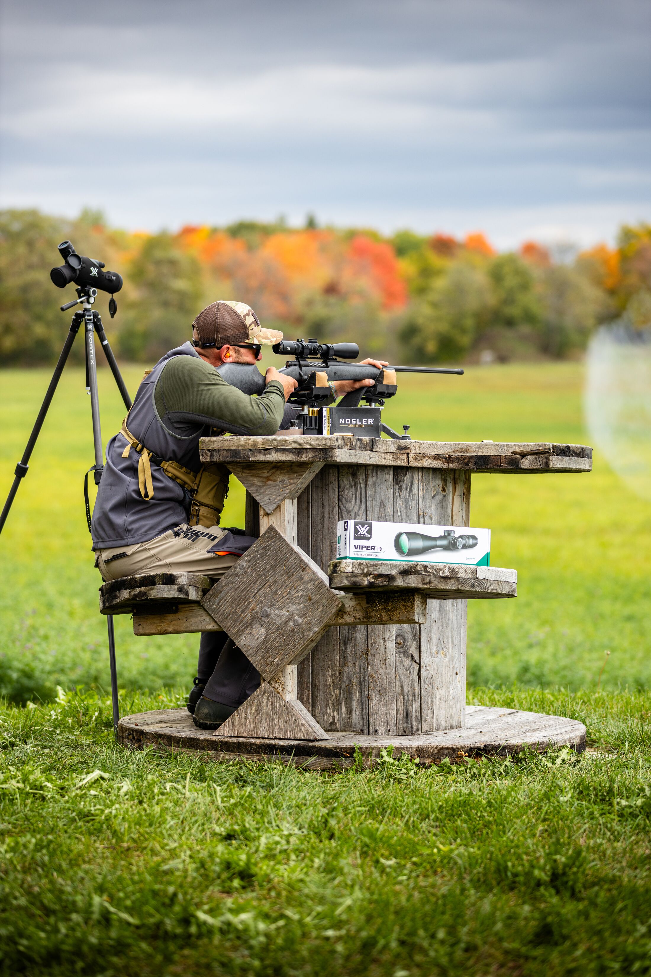 Hunter fires rifle at the range, hunting basics concept. 
