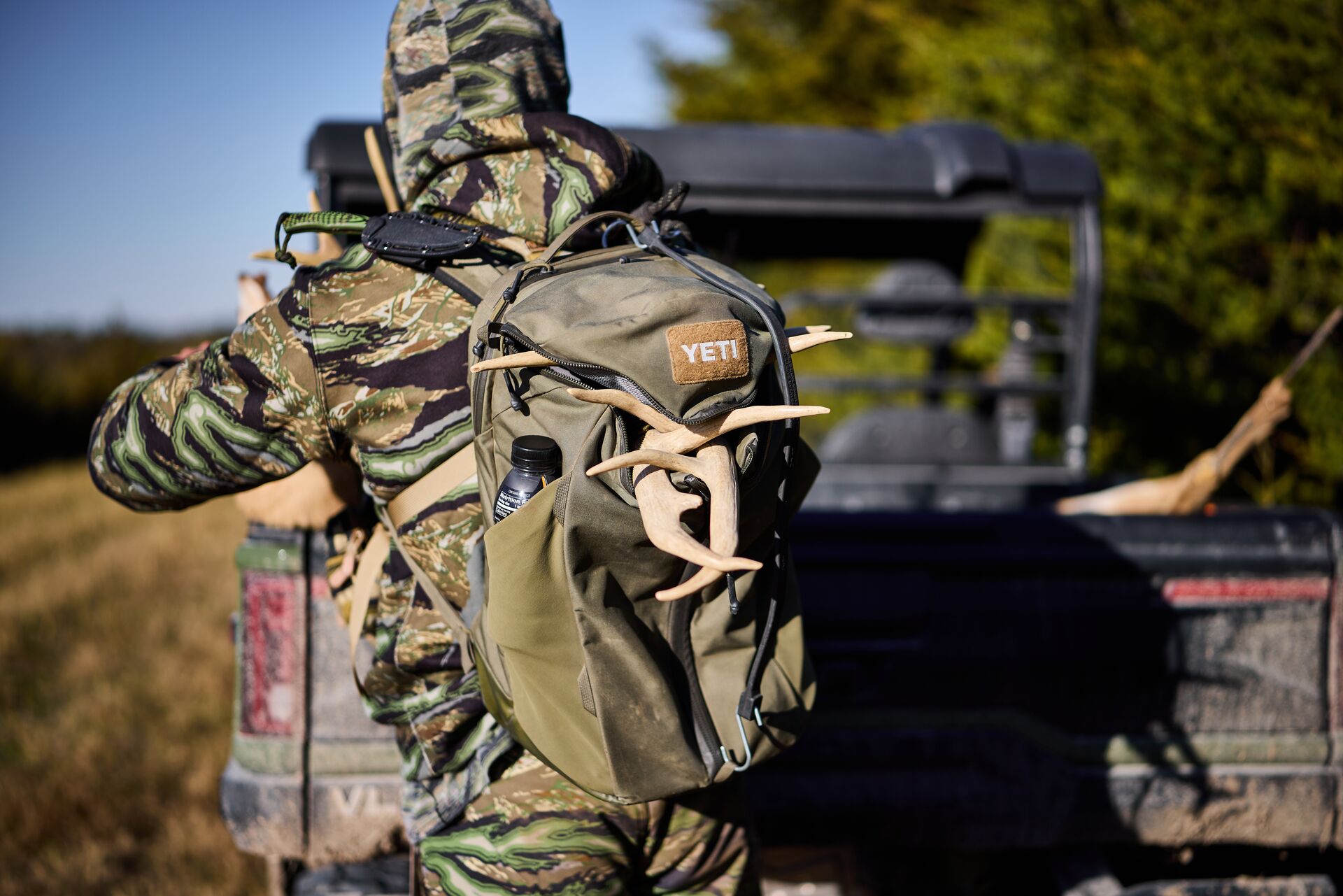 Hunter with full pack, carry a hunting emergency kit concept.