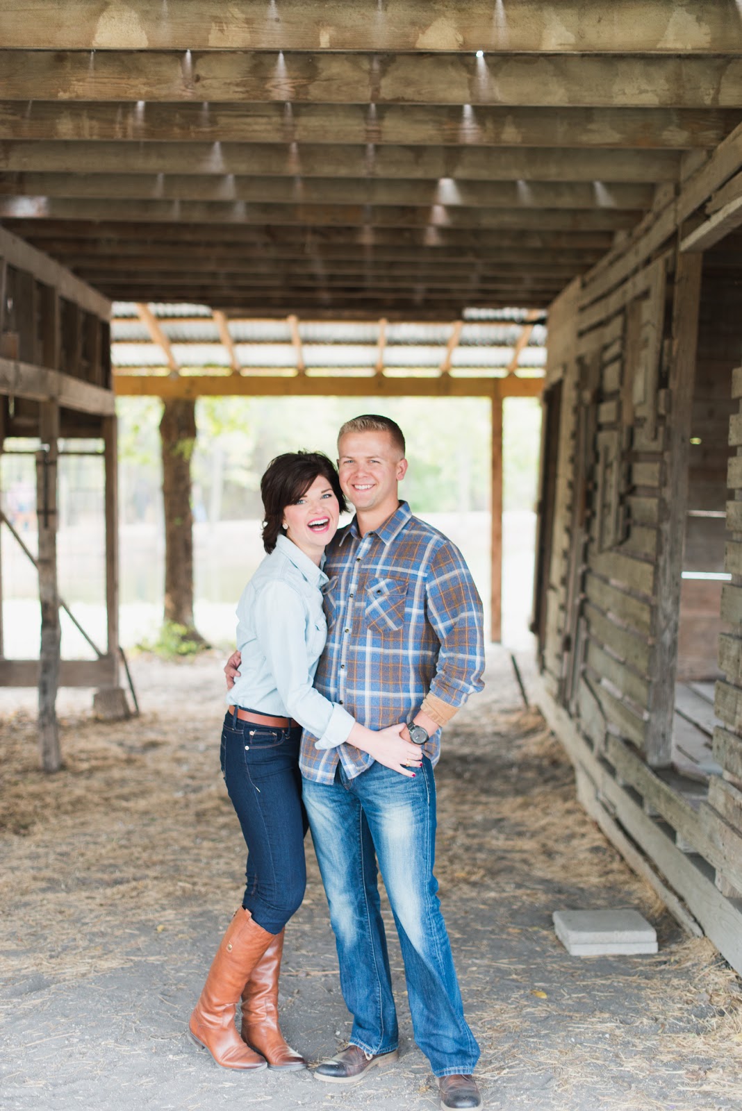 A couple poses together in a barn, safe hunting education concept. 