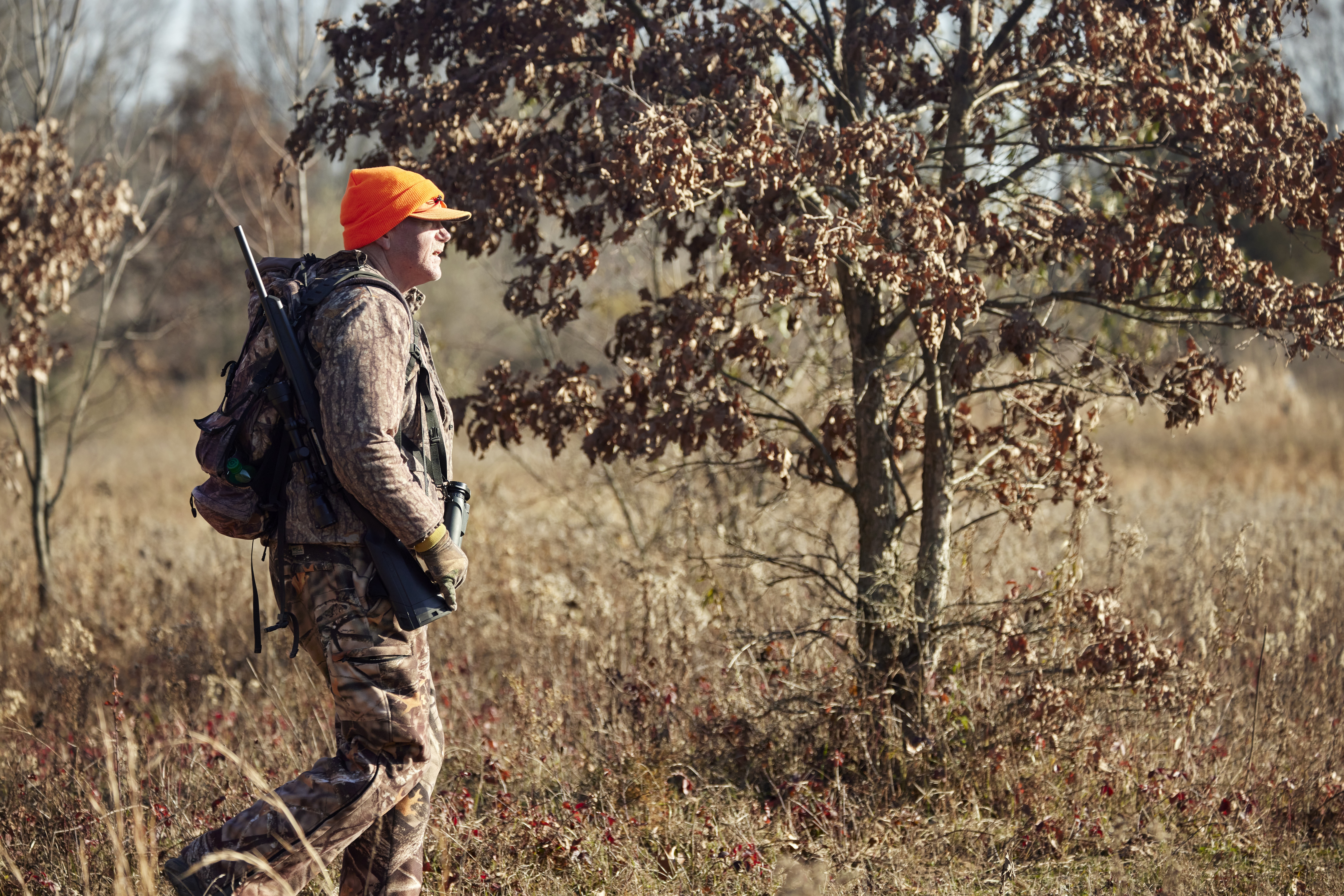 A hunter walks in a field, hunter education concept. 